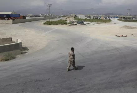 A member of the Afghan security forces walks in the sprawling Bagram air base after the American military departed, in Parwan province north of Kabul, Afghanistan, Monday, July 5, 2021.