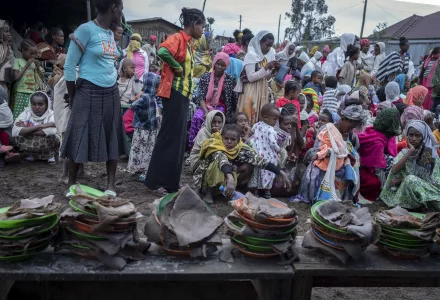 Displaced Ethiopians from different towns in the Amhara region wait for food to be distributed at lunchtime at a center for the internally-displaced in Debark, in the Amhara region of northern Ethiopia 