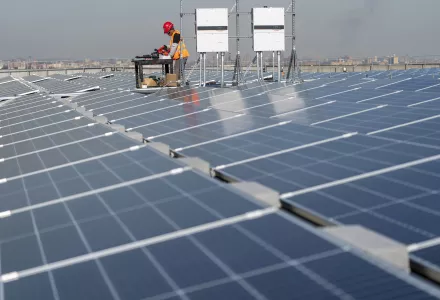 Electricians install solar panels.
