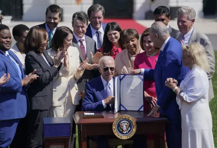 President Joe Biden holds the “CHIPS and Science Act of 2022” after signing it during a ceremony on the South Lawn of the White House, Tuesday, Aug. 9, 2022, in Washington.