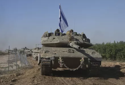 A convoy of Israeli army tanks maneuvers near Israel's border after leaving Gaza, southern Israel, on Friday, Nov. 24, 2023.