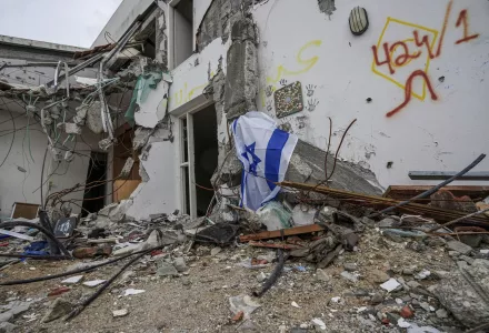 A battle-scarred home draped with an Israeli flag in Kibbutz Be'eri, an Israeli communal farm on the Gaza border. AP Photo/Tsafrir Abayov