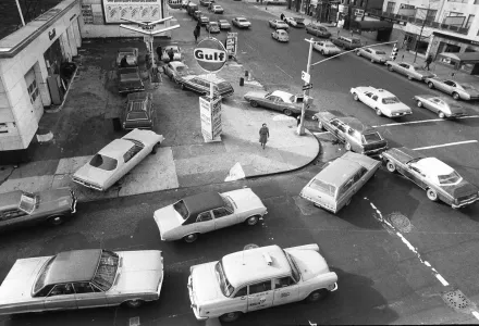Black and white photo showing cars line up in two directions at a gas station in New York City in 1973.