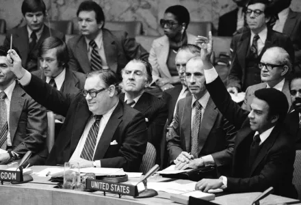 Ambassador Ivor Richard, left, of the United Kingdom, and U.S. Ambassador Andrew Young, right, raise their arms during vote, Friday, Nov. 4, 1977 at the United Nations Security Council. 