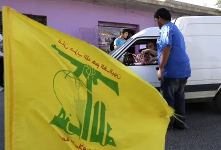 Hezbollah supporters distribute sweets to passersby, as they celebrate the fall of the Syrian town of Qusair to forces loyal to President Bashar Assad and Hezbollah fighters, in Bazzalieh village, Lebanon, near the Lebanese-Syrian border, Wednesday, June 5, 2013.
