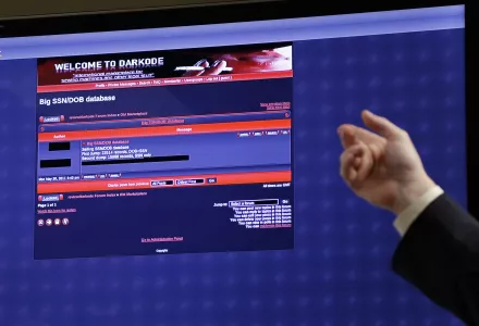 hand pointing at a screen displaying a screenshot from Darkcode