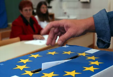 A Slovenian casts his ballot in a box bearing a European Union crest at a polling station in Grosuplje near Ljubljana, Sunday, Oct. 3, 2004. Nationwide general elections are taking place in Slovenia on Sunday. Slovenia joined the EU and NATO earlier this year.