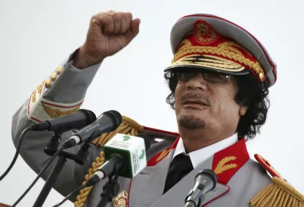 In this June 12, 2010 file photo, Libyan leader Moammar Gadhafi talks during a ceremony to mark the 40th anniversary of the evacuation of the American military bases in the country, in Tripoli, Libya (AP Photo/ Abdel Magid Al Fergany, File).