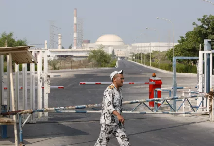 An Iranian security guard walks past a gate of the Bushehr nuclear power plant in Iran in 2010 (AP Photo/Vahid Salemi).