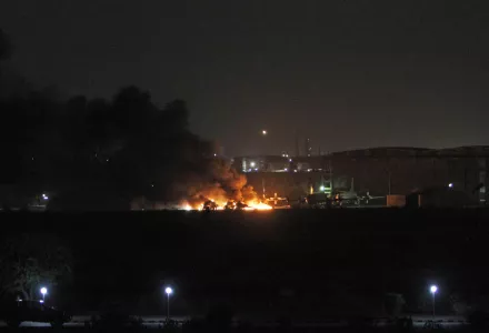 A building at a Pakistani naval aviation base burns during an attack by a substantial group of well-armed, well-trained militants, apparently with insider help, in May 2011. Nuclear weapons and materials must be protected against comparable adversary capabilities and tactics (AP Photo/Shakil Adil).