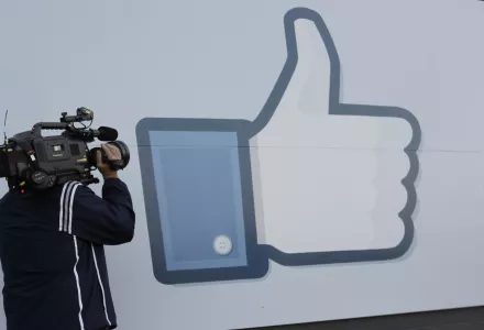 A television photographer shoots the Like sign outside of Facebook headquarters in Menlo Park, California on Friday, May 18, 2012. (AP Photo/Paul Sakuma)