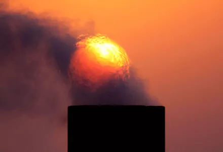 Exhaust rises from an oil facility in the desert field of Sakhir, Bahrain, September 2009.