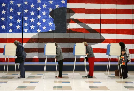 Voters line up in voting booths to cast their ballots at Robious Elementary School in Richmond, Va. on Tuesday, Nov. 8, 2016. The mural in the background was painted by 3rd and 4th graders at the school in preparation for Veterans Day.