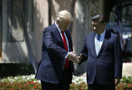 Presidents Trump and Xi shake hands.