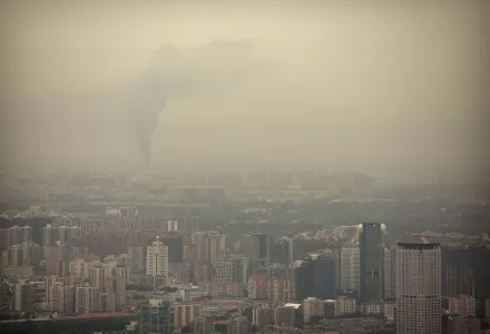 Smoke rises above the skyline of Beijing on a moderately polluted day, Saturday, Aug. 26, 2017. (AP Photo/Mark Schiefelbein)