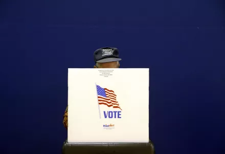 A voter fills out a ballot at a polling place.