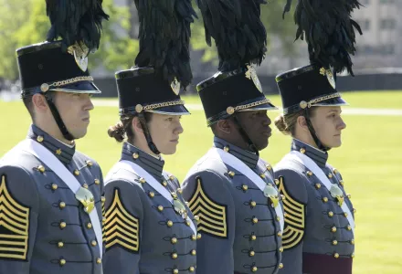 Photo of two men and two women marching at West Point graduation in May 2019.