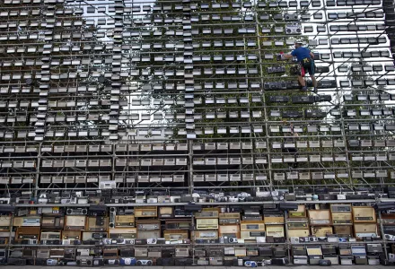 A technician prepares a giant construction made up of nearly 1,500 old radios on Vilnius Cathedral square, to commemorate events of 1989 when analog radios were used to coordinate the so-called Baltic Way human chain, in Vilnius, Lithuania, Friday, Aug. 23, 2019.