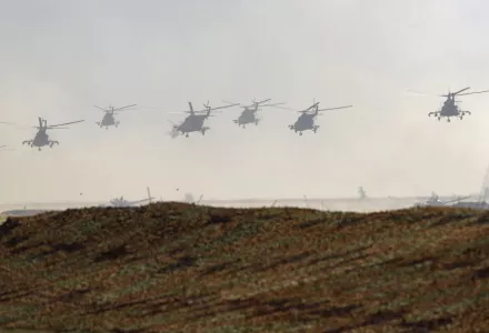 Military helicopters fly over the training ground during strategic command and staff exercises Center-2019 at Donguz shooting range near Orenburg, Russia, Friday, Sept. 20, 2019. 