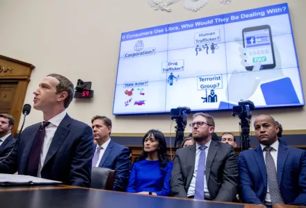The words "If Consumers Use Libra, Who Would They Be Dealing With?" is displayed on a monitor behind Facebook CEO Mark Zuckerberg as he testifies before a House Financial Services Committee hearing on Capitol Hill in Washington, Wednesday, Oct. 23, 2019, on Facebook's impact on the financial services and housing sectors.