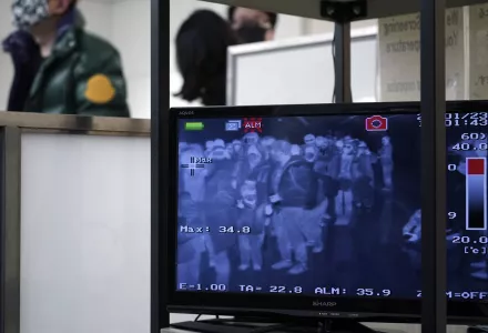 Travelers from China’s Wuhan and other cities go through body temperature scanners at Narita international airport in Narita, near Tokyo, Thursday, Jan. 23, 2020.