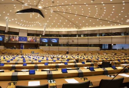 A MEP walks in the mostly-vacant Plenary chamber of the European Parliament in Brussels, Tuesday, March 10, 2020.