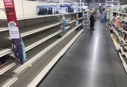 A shopper looks at items near empty shelves at a grocery store in Warrington, Pa., Tuesday, March 17, 2020. Coronavirus concerns have led to consumer panic buying of grocery staples. (AP Photo/Matt Rourke)