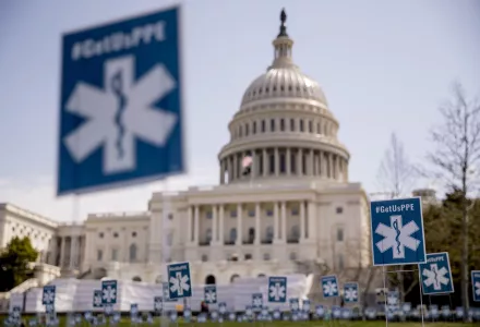 Advocacy groups display a thousand signs that read #GetUsPPE, along images of health care workers, in a call for personal protective equipment for frontline health workers during the coronavirus outbreak, on the West Lawn of the U.S. Capitol, Friday, April 17, 2020, in Washington.