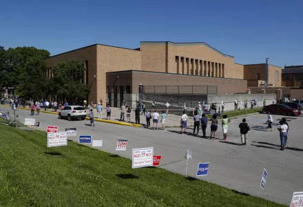 Voters wait in a line outside Broad Ripple High School to vote in the Indiana primary in Indianapolis, Tuesday, June 2, 2020 after coronavirus concerns prompted officials to delay the primary from its original May 5 date.