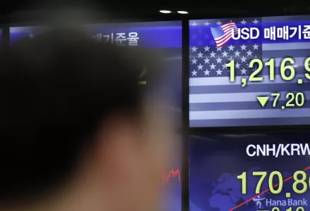 A currency trader works near the screens showing the foreign exchange rates at the foreign exchange dealing room in Seoul, South Korea, Thursday, June 4, 2020. 