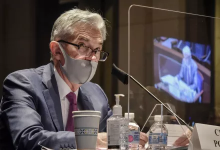 Federal Reserve Board Chairman Jerome Powell, reflected in the sneeze guard set up between himself and members of the House Committee on Financial Services, speaks during a hearing on oversight of the Treasury Department and Federal Reserve pandemic response, Tuesday, June 30, 2020 on Capitol Hill in Washington. 