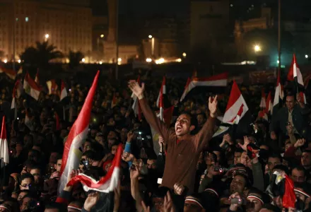 Egyptians celebrate the news of the resignation of President Hosni Mubarak, Feb. 11, 2011. (AP Photo/Ben Curtis)