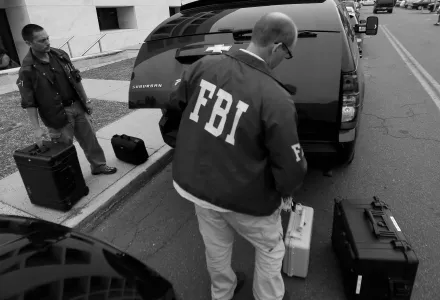FBI agents leave a raid in Trenton, N.J. on July 19, 2012