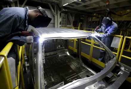 In this March 13, 2015 photo, workers weld body panels on the new aluminum-alloy body Ford F-150 truck at the company's Kansas City Assembly Plant in Claycomo, Mo (AP Photo/Charlie Riedel).