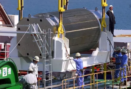 A container of uranium oxide and plutonium (MOX) is unloaded from a British plutonium transport ship at a port in Iwaki, Japan (AP Photo/Shizuo Kambayashi, File).