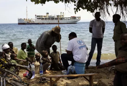 Refugees wait to board a UN ship