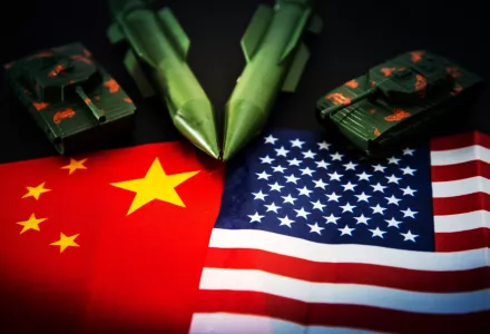 Photo of China and U.S. flags with military items
