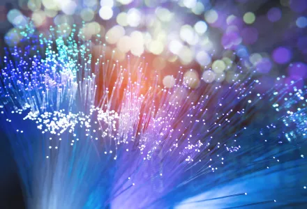 A close-up of fiber optic cables with many colors