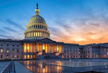 The U.S. Capitol building with the sun rising in the background