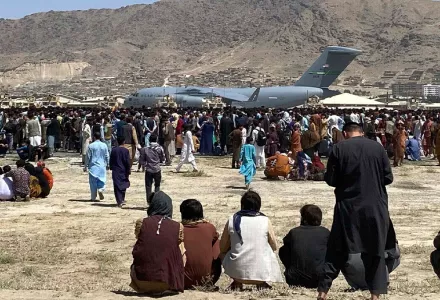 Hundreds of people gather near a U.S. Air Force C-17 transport plane along the perimeter at the international airport in Kabul, Afghanistan on August 16, 2021. (AP Photo/Shekib Rahmani, File)