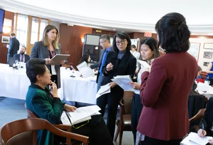 General Hao Yeli (second from left) and colleagues from the China working group discuss responses during the fictitious cyber scenario of a third party attack on critical infrastructure.