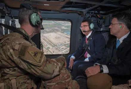 Secretary of Defense Ash Carter speaks with Army Lt. Gen. Sean MacFarland, Commander Combined Joint Task Force- Operation Inherent Resolve as they fly to the Green Zone in Baghdad, Iraq in a UH-60 helicopter to meet with Iraqi leaders to discuss matters of usual importance Apr. 18, 2016.