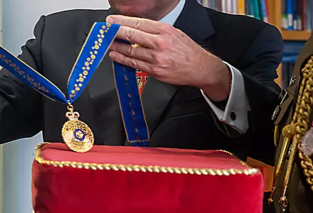 A close up of the Order of Australia medal.