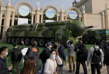 Visitors tour past military vehicles carrying the Dong Feng 41 and DF-17 ballistic missiles at the Beijing Exhibition Hall in Beijing on Oct. 12, 2022.