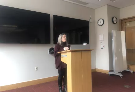 Sarah Ladislaw stands at podium