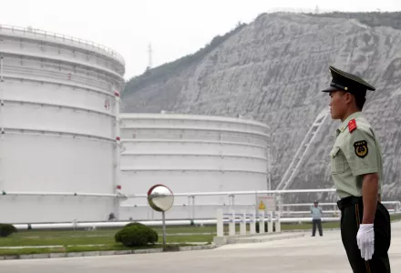 Security guards watch near oil tanks at Zhoushan Oil Reserve in Zhoushan in Zhejiang Province, China, June 3, 2009.