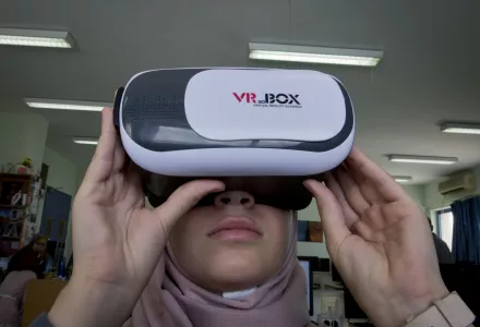 In this Thursday, Aug. 2, 2018 photo, Wassan al-Sayyed,17, uses a 3D glasses headset that is running the team's virtual reality game "Be a Fire Fighter" in the West Bank city of Nablus. For the 11th graders from the Israeli-occupied West Bank, the ticket of admission to the World Pitch Summit signals a particularly dramatic leap because of the limited opportunities at home. 