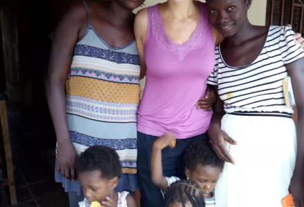 Zoe Marks (center) with her translator Patricia Turay and her family in Makeni, Sierra Leone, where Marks was researching impacts of civil war and its aftermath.