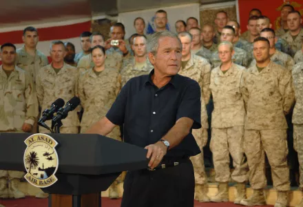 President George W. Bush thanks U.S. troops in Al Asad, Iraq, Sept. 3, 2007. He stands at a podium in front of rows of troops in uniform. 