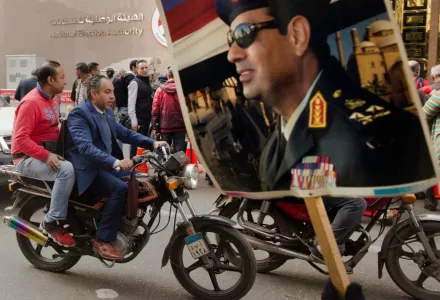 A supporter holds a poster showing President Abdel Fatah al-Sissi, in front of the National Elections Authority in Cairo, on Jan. 29. (AP)